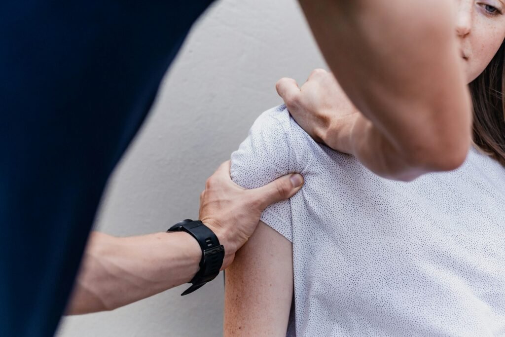 Fisioterapeuta tratando el hombro de un paciente